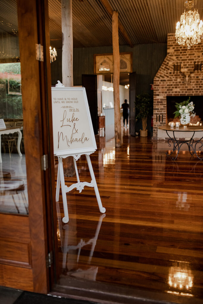 Wedding sign for Mikaela and Luke at the entrance of the reception hall at Mali Brae Farm