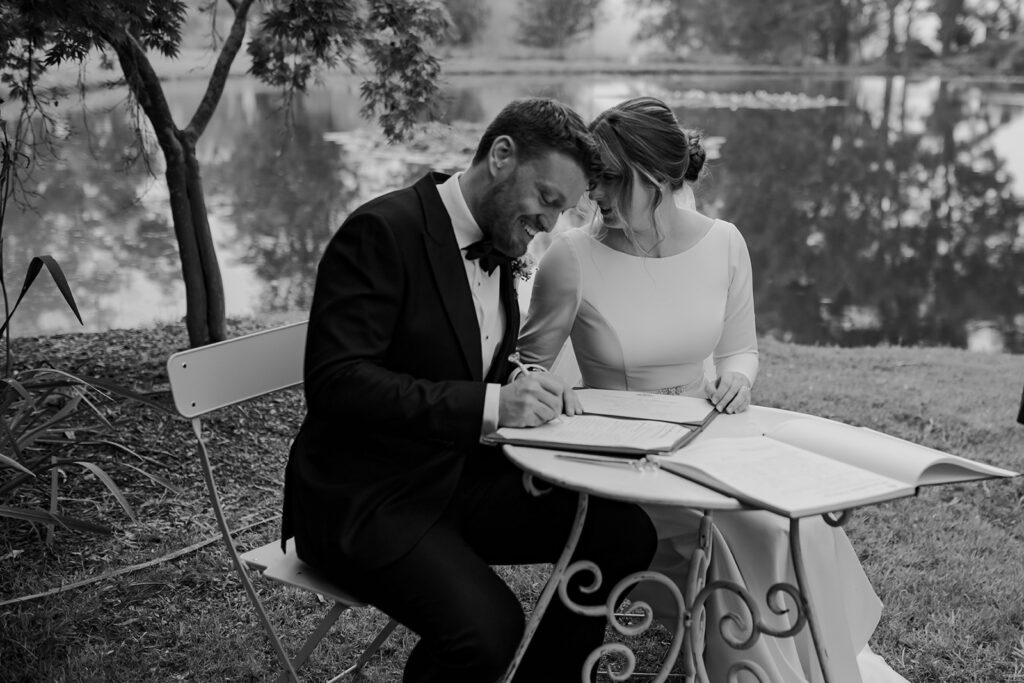 Bride and groom signing wedding papers at their southern highlands wedding